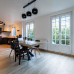 Cuisine moderne avec table et chaises en bois.