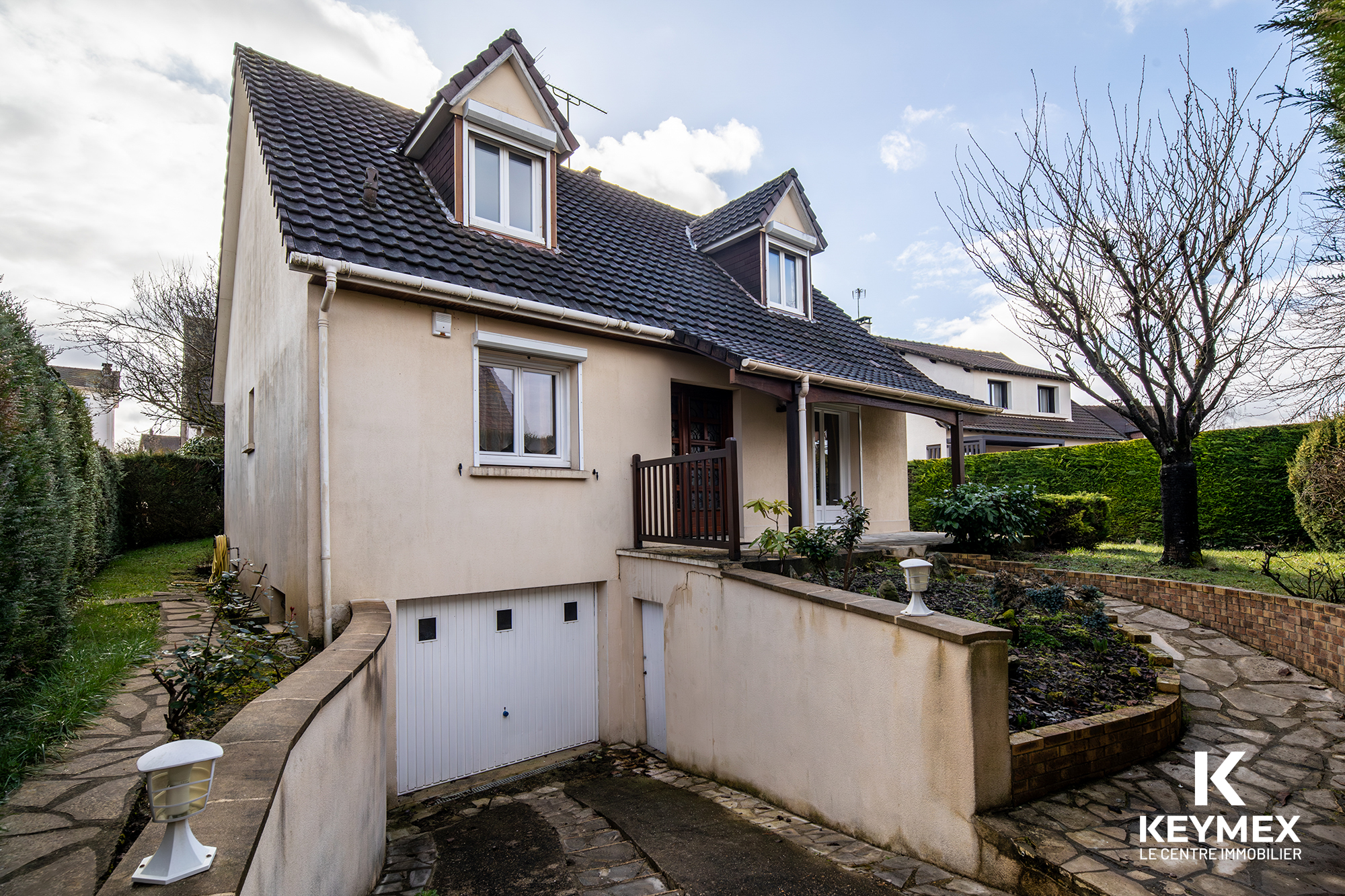 Maison moderne avec garage et jardin.