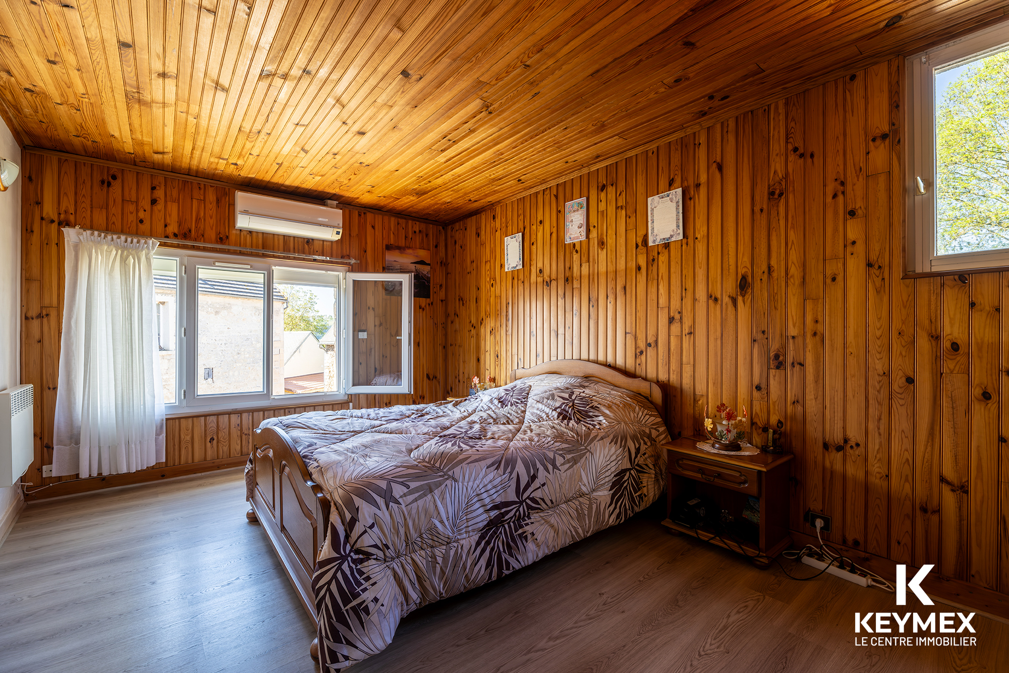 Chambre avec mur en bois et lit simple.