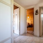 Hall d'entrée avec portes vers chambres et salle de bain.