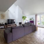 Salon moderne avec canapés et télévision.